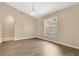 Inviting living room with a vaulted ceiling, natural light, and wood-look flooring at 922 Hatteras Ave, Minneola, FL 34715