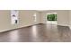 Spacious living room featuring a window and sliding glass door providing plenty of natural light at 922 Hatteras Ave, Minneola, FL 34715