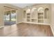 Bright living room features sliding glass doors to the outside and custom built-in shelving at 922 Hatteras Ave, Minneola, FL 34715