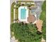 Aerial shot of a community pool surrounded by lush landscaping and a parking area at 922 Hatteras Ave, Minneola, FL 34715