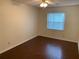 A bright bedroom featuring hardwood floors, a window with blinds, and neutral paint at 9926 Turf Way # 8, Orlando, FL 32837