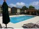 Inviting community pool area with lounge chairs and shaded seating, ideal for relaxing and enjoying sunny days at 9926 Turf Way # 8, Orlando, FL 32837