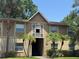 Inviting two-story condo building with manicured lawn and small palm trees at 9926 Turf Way # 8, Orlando, FL 32837