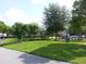 A verdant green space with walking paths, well-maintained landscaping and mature trees at 9926 Turf Way # 8, Orlando, FL 32837