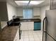 Efficient kitchen features white cabinets, stainless steel refrigerator, and modern appliances at 9926 Turf Way # 8, Orlando, FL 32837