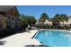 A resort-style pool area featuring a lounge area, bbq grill, and well-manicured landscaping at 9926 Turf Way # 8, Orlando, FL 32837