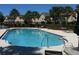 A refreshing pool area featuring palm trees, lounge chairs, and well-maintained facilities at 9926 Turf Way # 8, Orlando, FL 32837