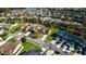 Beautiful, peaceful neighborhood with manicured lawns and mature trees under a blue sky at 997 La Mirada Ct, Kissimmee, FL 34744