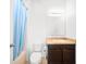 Functional bathroom features a vanity, toilet, tub with shower, and natural light from the window at 997 La Mirada Ct, Kissimmee, FL 34744
