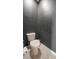 Powder room with tiled flooring, tan toilet and painted walls at 997 La Mirada Ct, Kissimmee, FL 34744