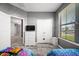 A bright bedroom is furnished with hardwood floors, and it has a double-door closet and window at 997 La Mirada Ct, Kissimmee, FL 34744