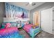 Whimsical ' room boasting themed decor, two twin beds, and a well-lit atmosphere for play and rest at 997 La Mirada Ct, Kissimmee, FL 34744