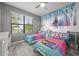 Themed ' room with playful decor, bright-colored beds, and cheerful natural light from the window at 997 La Mirada Ct, Kissimmee, FL 34744
