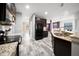 Kitchen with granite counters, an island, and stainless appliances has access to the living room at 997 La Mirada Ct, Kissimmee, FL 34744