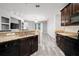 Modern kitchen boasts granite countertops, stainless steel appliances, and an open view to the living area at 997 La Mirada Ct, Kissimmee, FL 34744