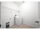 A functional laundry room with a washing machine and storage shelving for convenience at 997 La Mirada Ct, Kissimmee, FL 34744