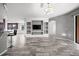 Open-concept living room featuring a built-in media center and stylish tile flooring at 997 La Mirada Ct, Kissimmee, FL 34744
