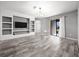 Bright living room with sliding glass doors, decorative lighting and built-in media center at 997 La Mirada Ct, Kissimmee, FL 34744