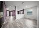 Large living room with new floors and paint connects the kitchen, dining, and other areas of the home at 997 La Mirada Ct, Kissimmee, FL 34744