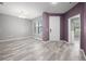 Inviting living room features neutral paint, wood-look tile flooring, and plenty of natural light at 997 La Mirada Ct, Kissimmee, FL 34744