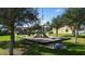 Community playground area with green lawn and park bench seating at 997 La Mirada Ct, Kissimmee, FL 34744