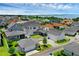 Aerial view features a charming two-story home with a detached garage, complete with a fenced yard, nestled in a vibrant neighborhood at 1071 Kershaw Dr, Winter Garden, FL 34787