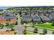 Wide neighborhood aerial view featuring a well-maintained two-story home with a landscaped front yard, in a lakeside community at 1071 Kershaw Dr, Winter Garden, FL 34787