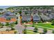Wide neighborhood aerial view featuring a well-maintained two-story home with a landscaped front yard, in a lakeside community at 1071 Kershaw Dr, Winter Garden, FL 34787
