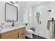 Modern bathroom featuring a sleek vanity, frameless glass shower and designer finishes at 1071 Kershaw Dr, Winter Garden, FL 34787