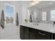 Bathroom showcasing a sleek vanity with brass accents, ample lighting and a soaking tub at 1071 Kershaw Dr, Winter Garden, FL 34787