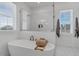Bright bathroom features a freestanding tub and frameless glass shower, offering a luxurious retreat at 1071 Kershaw Dr, Winter Garden, FL 34787