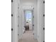 Hallway view into a well-lit bedroom featuring a comfortable bed and a cozy nightstand at 1071 Kershaw Dr, Winter Garden, FL 34787