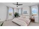 Bright bedroom featuring neutral tones, large windows, and a ceiling fan for a relaxing ambiance at 1071 Kershaw Dr, Winter Garden, FL 34787