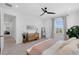 Sunlit bedroom features a dresser, a full length mirror, and plush carpet for added comfort at 1071 Kershaw Dr, Winter Garden, FL 34787