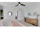 Bright, airy bedroom features a natural wood dresser and a round mirror, creating a serene space at 1071 Kershaw Dr, Winter Garden, FL 34787