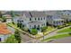 Charming two-story home boasts a welcoming front porch, lush landscaping, and a white picket fence, creating a classic curb appeal at 1071 Kershaw Dr, Winter Garden, FL 34787