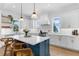 Modern kitchen with white cabinets, a large island, and stylish lighting at 1071 Kershaw Dr, Winter Garden, FL 34787