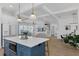 Spacious kitchen with an island, modern appliances, and a view of the living area at 1071 Kershaw Dr, Winter Garden, FL 34787