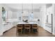 Bright kitchen featuring white cabinets, a blue island, and stainless steel appliances at 1071 Kershaw Dr, Winter Garden, FL 34787