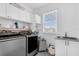 Well-lit laundry room featuring modern appliances, ample storage, and sleek design at 1071 Kershaw Dr, Winter Garden, FL 34787