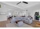 Open-concept living room with a plush gray sectional and seamless flow to dining and kitchen areas at 1071 Kershaw Dr, Winter Garden, FL 34787