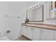 Bathroom with ample cabinet space, a large mirror, and a towel rack at 1084 Park Ridge Cir, Kissimmee, FL 34746