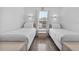 Clean bedroom features two twin beds with white linens, and a window at 1084 Park Ridge Cir, Kissimmee, FL 34746