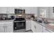 Modern kitchen with stainless steel oven, microwave, tiled backsplash and double sinks at 1084 Park Ridge Cir, Kissimmee, FL 34746