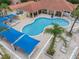 Aerial view of a community pool with ample seating and shade at 1084 Park Ridge Cir, Kissimmee, FL 34746