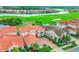 Aerial view of the neighborhood showcases tile roofs, manicured lawns, and a scenic golf course at 13125 Alderley Dr, Orlando, FL 32832