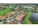 Scenic aerial view of lush landscaping with lakes, golf course and well-maintained community streets at 13125 Alderley Dr, Orlando, FL 32832