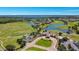 Scenic aerial shot of the golf course, lake, and community clubhouse at 13125 Alderley Dr, Orlando, FL 32832