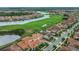 Expansive aerial view of neighborhood with beautiful water views, lush landscaping, and sidewalks at 13125 Alderley Dr, Orlando, FL 32832