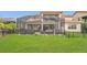 Backyard features a screened-in lanai with outdoor seating, hot tub and well-maintained lawn at 13125 Alderley Dr, Orlando, FL 32832